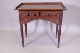 C19th Anglo Indian two drawer padouk writing table with three quarter gallery and carved floral