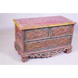 An antique painted hardwood chest of three drawers raised on a carved and pierced base, 85 x 44 x