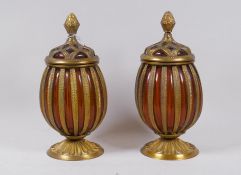 A Pair of amber glass urns and covers with brass mounts, 27cm high