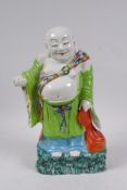 A Chinese polychrome porcelain figure of Buddha, 29cm high