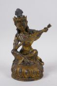 A Sino Tibetan gilt bronze figure of a musician, impressed double vajra mark to base, 22cm high