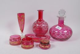 A cranberry glass dressing table part set with raised gilt decoration , vase 17cm high, a