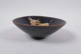 A Chinses Cizhou kiln conical bowl with kylin decoration, 15cm diameter