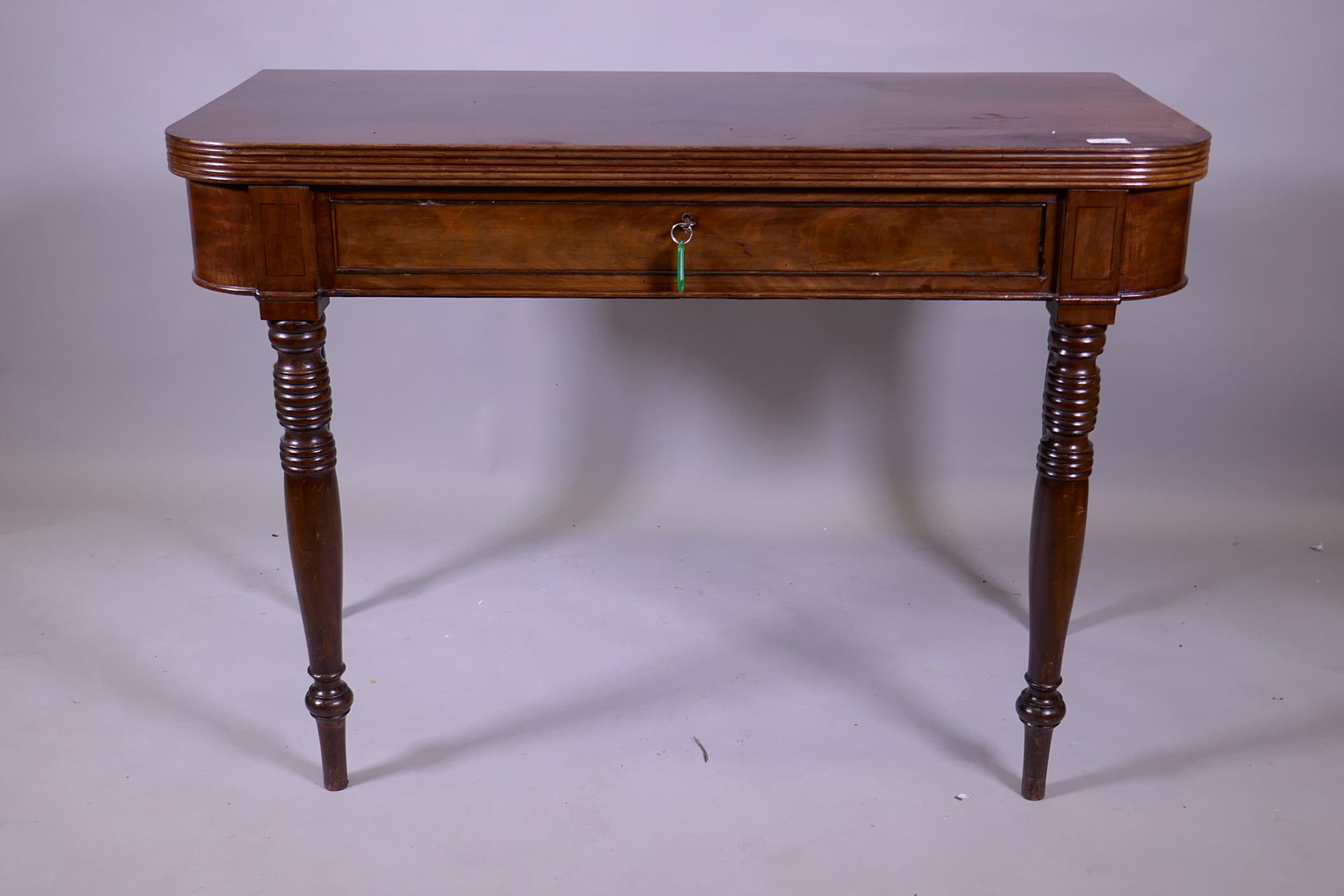 A Georgian mahogany D shaped dining table with reeded edge fold over top, raised on ring turned