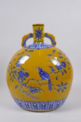 A Chinese imperial yellow ground porcelain moon flask with two handles and blue and white bird