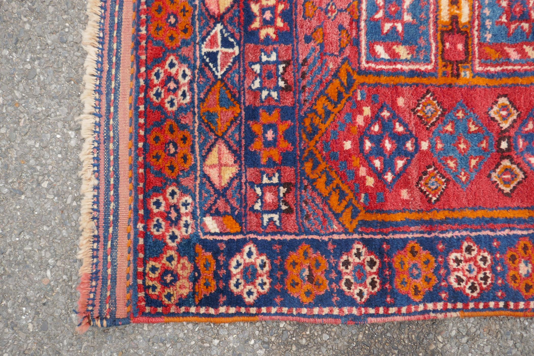 A Kurdish red ground full pile village rug/runner with unique geometric design, 290cm x 98cm - Image 6 of 7