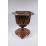 An inlaid mahogany wine cooler with pierced body and brass liner, 41cm high x 38cm diameter