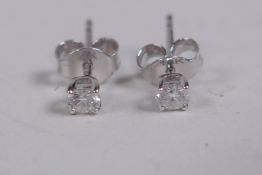 A pair of 18ct white gold stud earrings, approx 30 points
