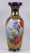 A Continental porcelain vase, blue glazed with gilt highlights and a finely painted panel, 40cm high