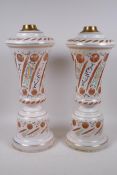 A pair of Bohemian painted rose coloured glass lamp bases, 44cm high