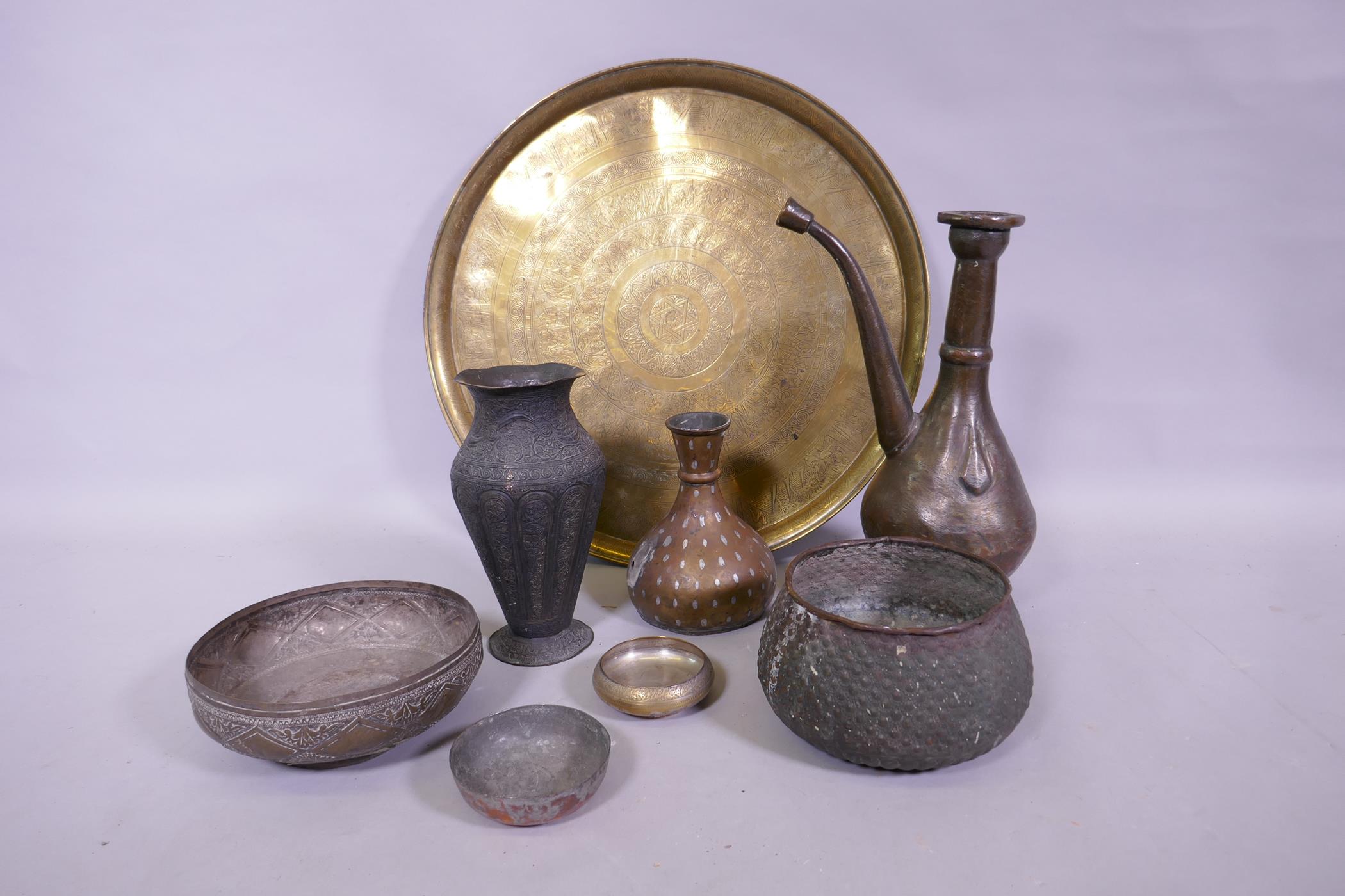 A collection of antique Middle Eastern and Indian metal ware, including an Egyptian brass tray, 57cm