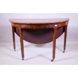 A Georgian mahogany demi lune table with fold over top, raised on square tapering supports with