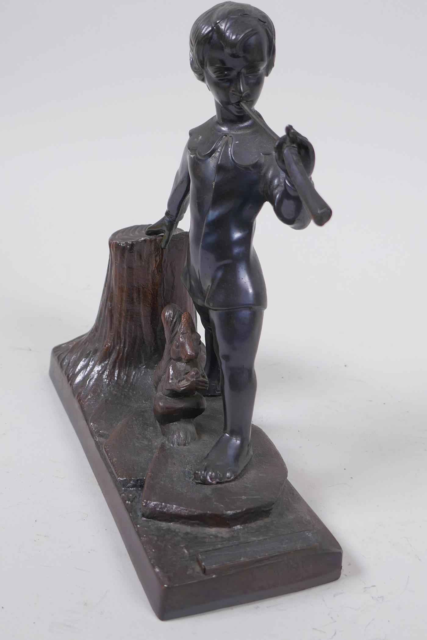 A spelter table top taper stand with striker, modelled as a boy piper and a squirrel, 17cm long - Image 2 of 4