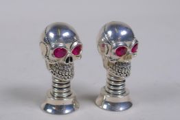 A pair of novelty silver plated skull condiments, 5cm