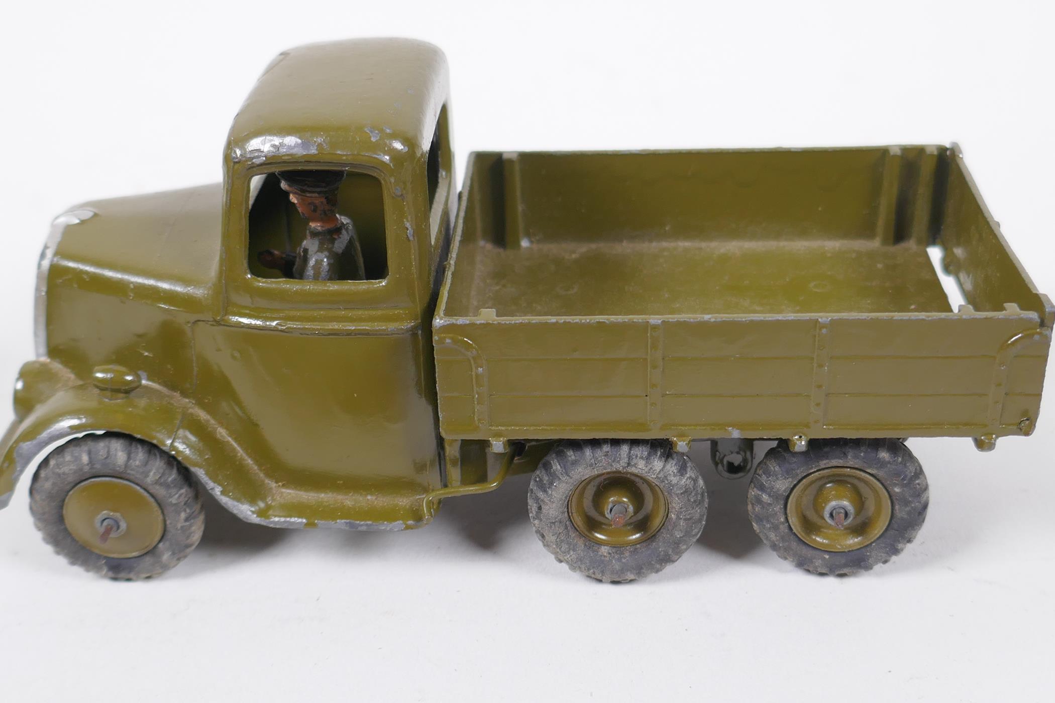 A Britains model six wheel army tipper truck with driver, a Britains Howitzer, two field guns, a - Image 4 of 5