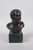 A Greco Roman bronze bust on a green marble socle, 14cm