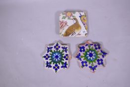 Two antique Islamic star shaped terracotta tiles and another, hand painted with a bird design, 18