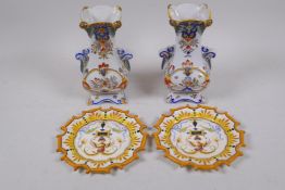 A pair of C19th faience pottery two handled vases with polychrome floral decoration, and a pair of