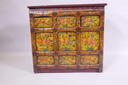 An oriental painted hardwood side cabinet with an imitation bamboo frame, 66 x 28cm, 60cm high