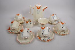 An Art Deco china tea service by Palissy, decorated with orange flowers, tea pot, jug, sugar bowl