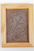 A bronze plaque cast with a leaf skeleton, monogramed, 10 x 15cm