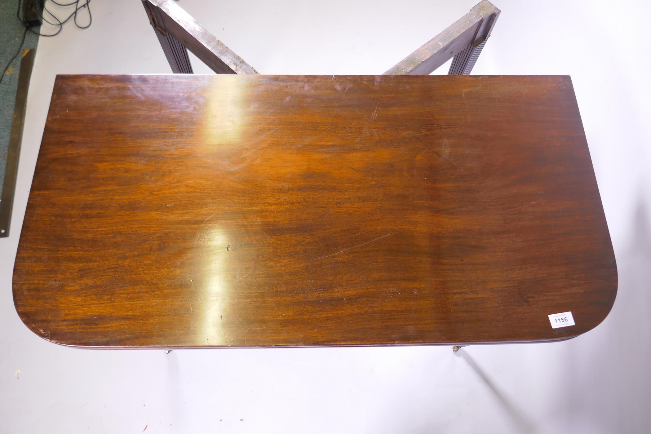 A Georgian mahogany D shaped tea table, raised on tapering reeded supports with brass castors, 102 x - Image 6 of 6
