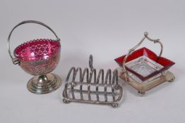 A hallmarked silver toast rack, 215g, a silver plated pedestal bowl with cranberry glass liner,