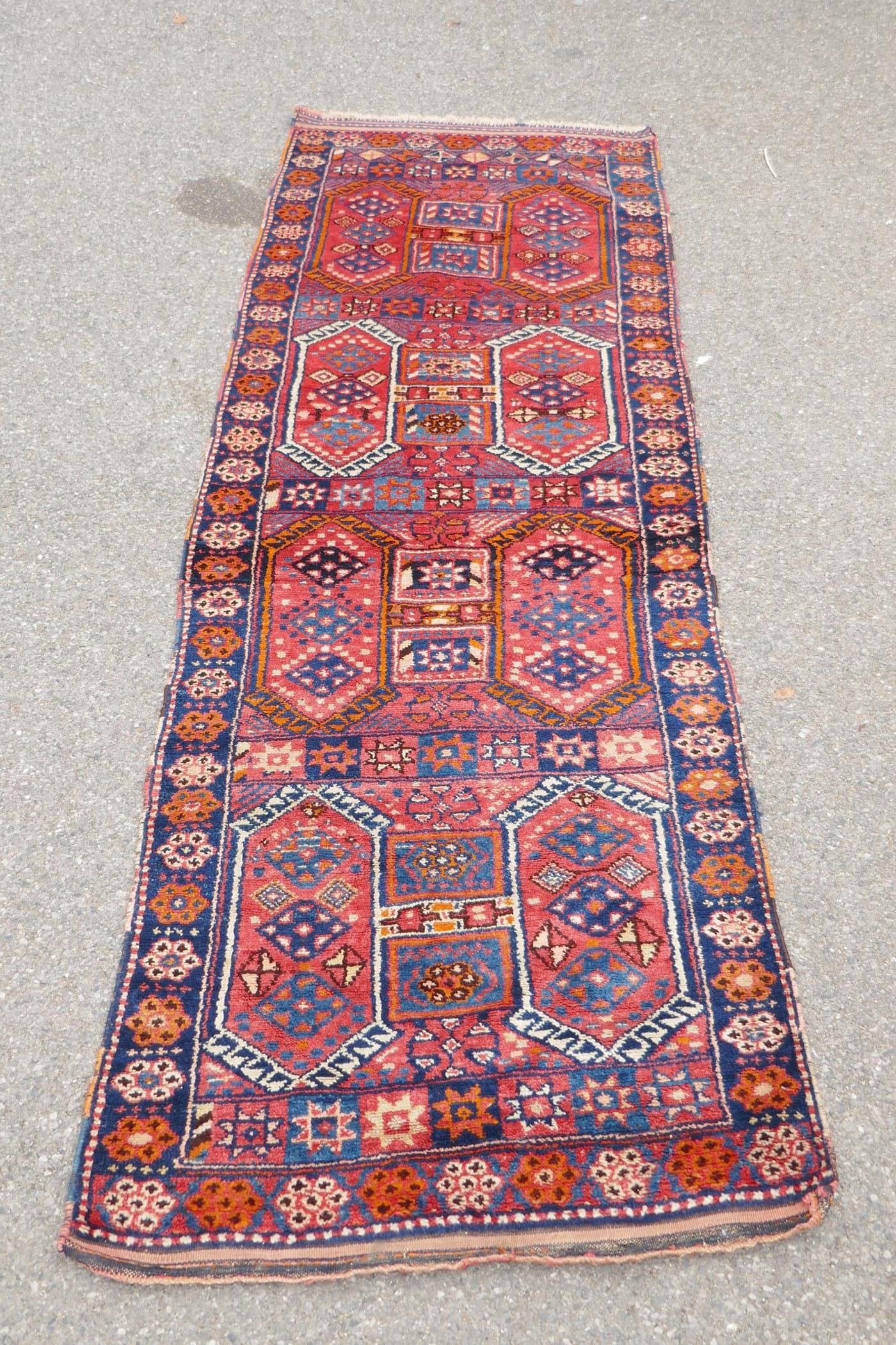 A Kurdish red ground full pile village rug/runner with unique geometric design, 290cm x 98cm - Image 2 of 7