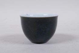 A Japanese famille noir porcelain sake bowl, 4 character mark to base, 7cm diameter