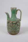 A Chinese Song style green glazed pottery jug, with chased lotus flower decoration, 23cm high