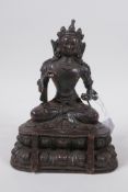 A Sino Tibetan bronze of Buddha seated on a lotus throne, 19cm high