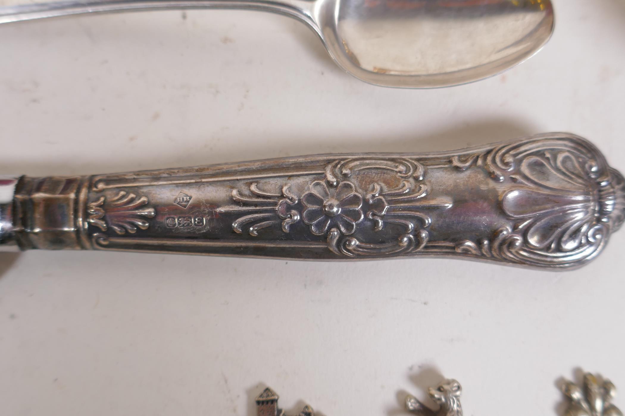 A collection of silver, silver plate and white metal items to include tea spoons, coin spoons, - Image 3 of 9