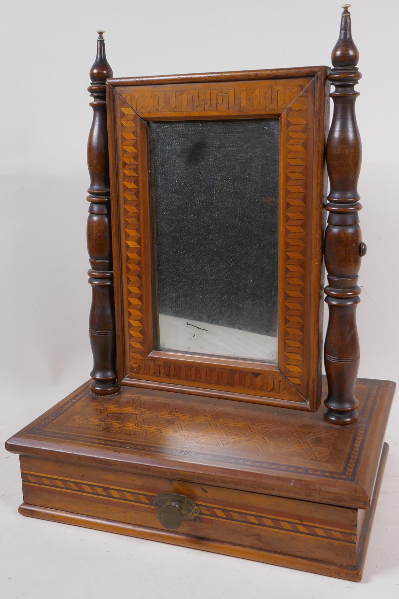 A small antique marquetry inlaid swing toilet mirror on single drawer base, 42cm high x 31cm wide