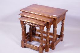 A nest of three Bevan Funnell oak occasional tables, raised on turned supports, 55 x 36 x 49cm