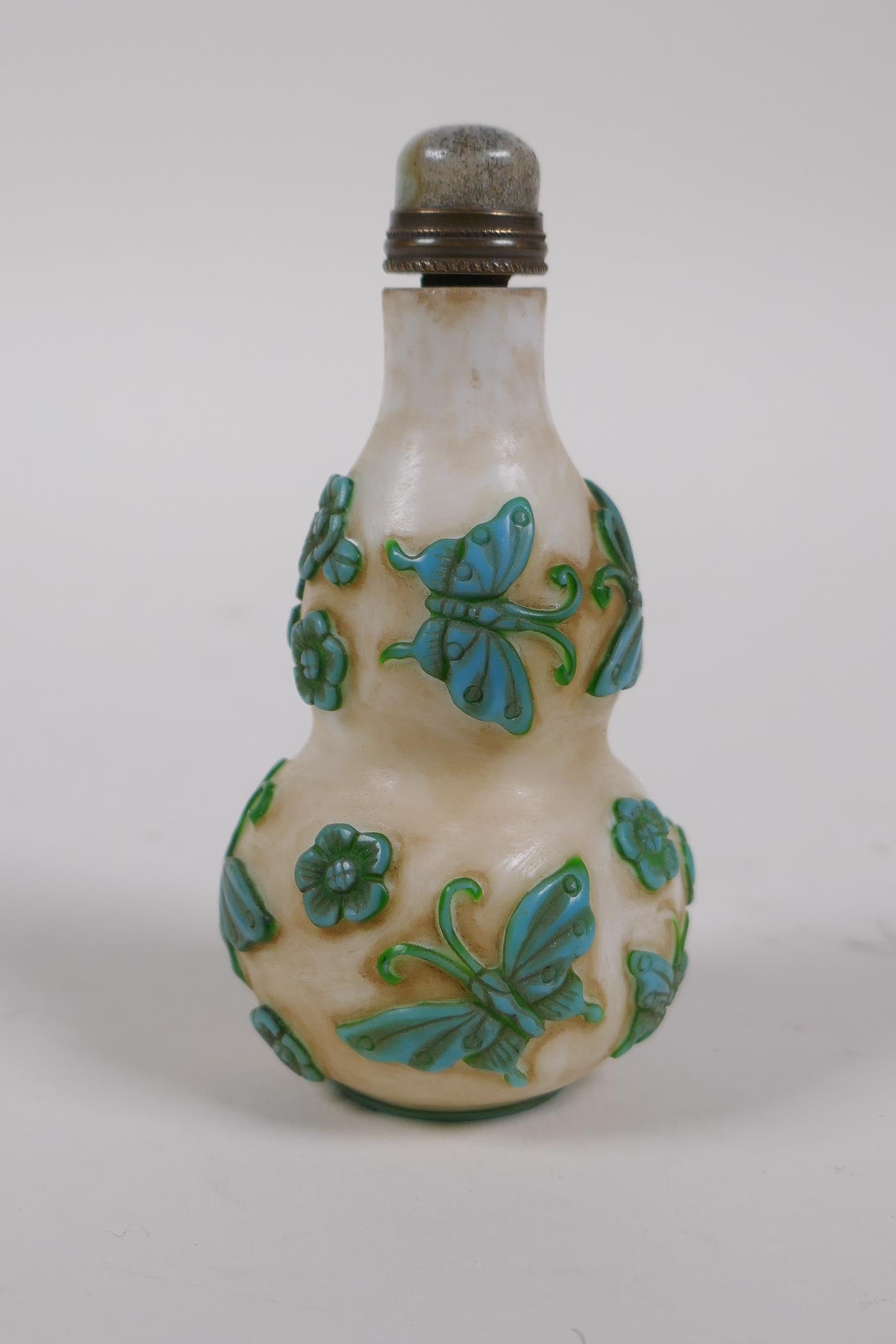 A Peking glass double gourd snuff bottle with raised butterfly decoration, 4 character mark to base,