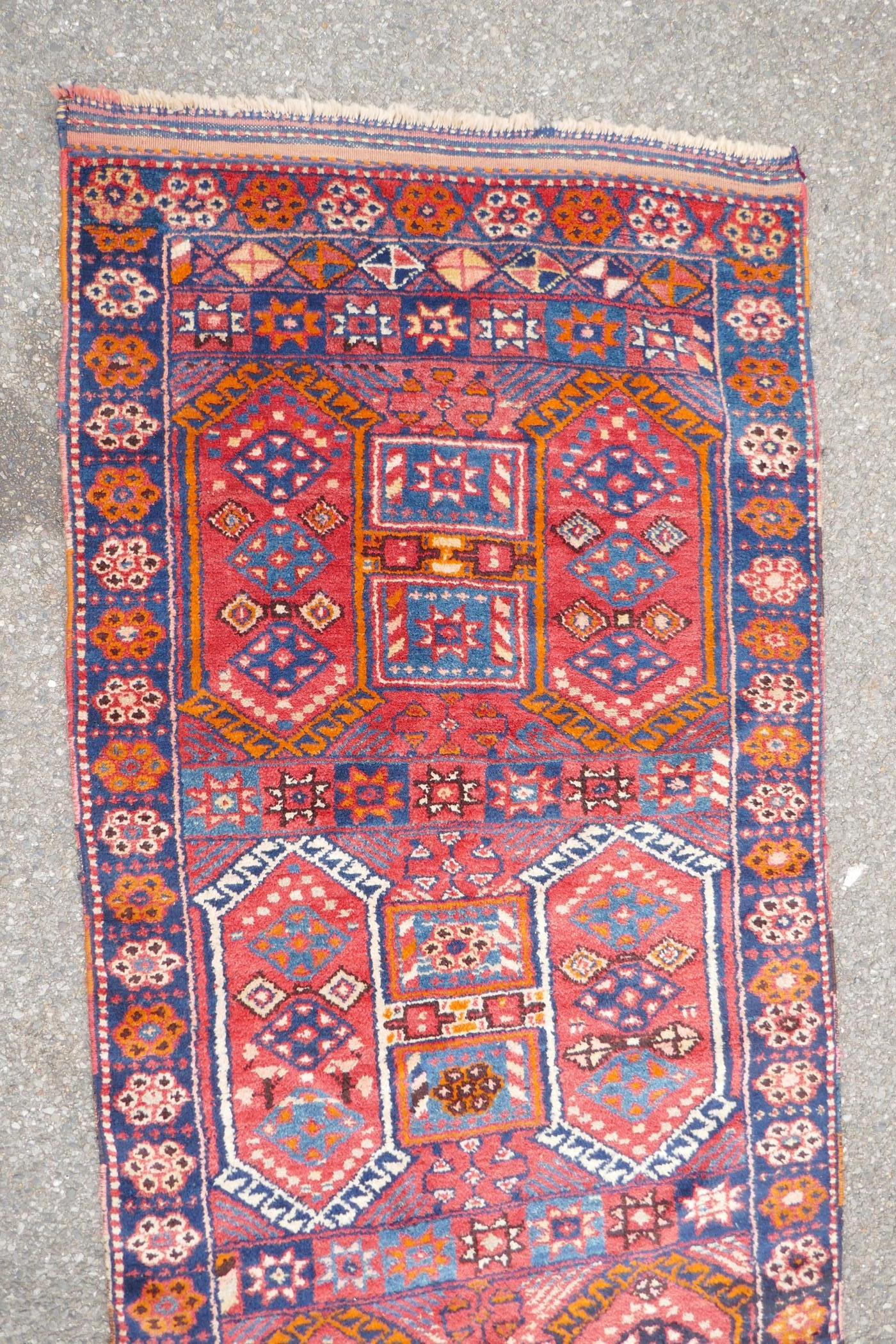 A Kurdish red ground full pile village rug/runner with unique geometric design, 290cm x 98cm - Image 5 of 7