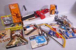 A collection of tools, including chain saw, electrical and vintage tools