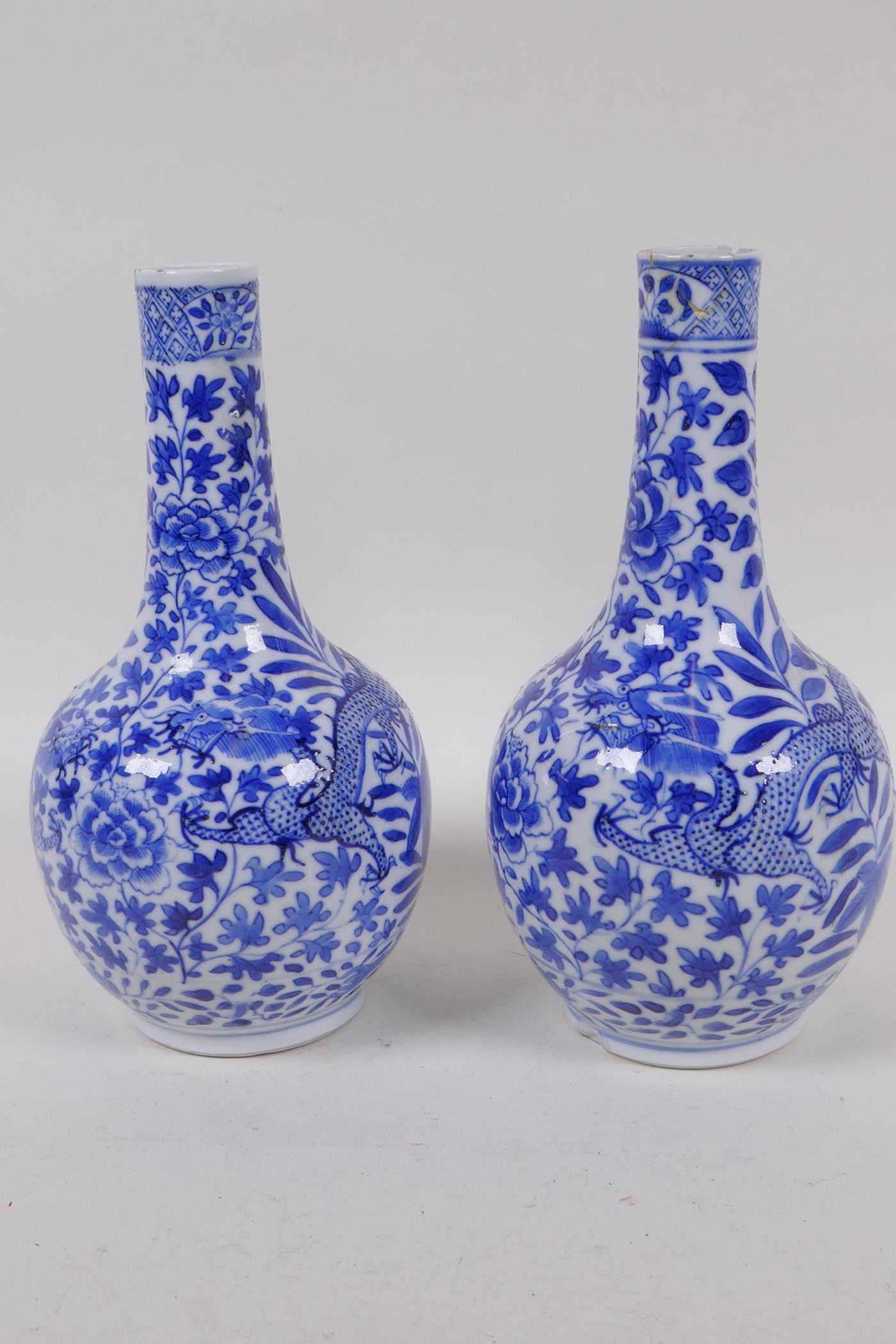 A pair of Chinese blue and white bottle vases decorated with dragons amongst foliage, KangXi 4 - Image 2 of 4