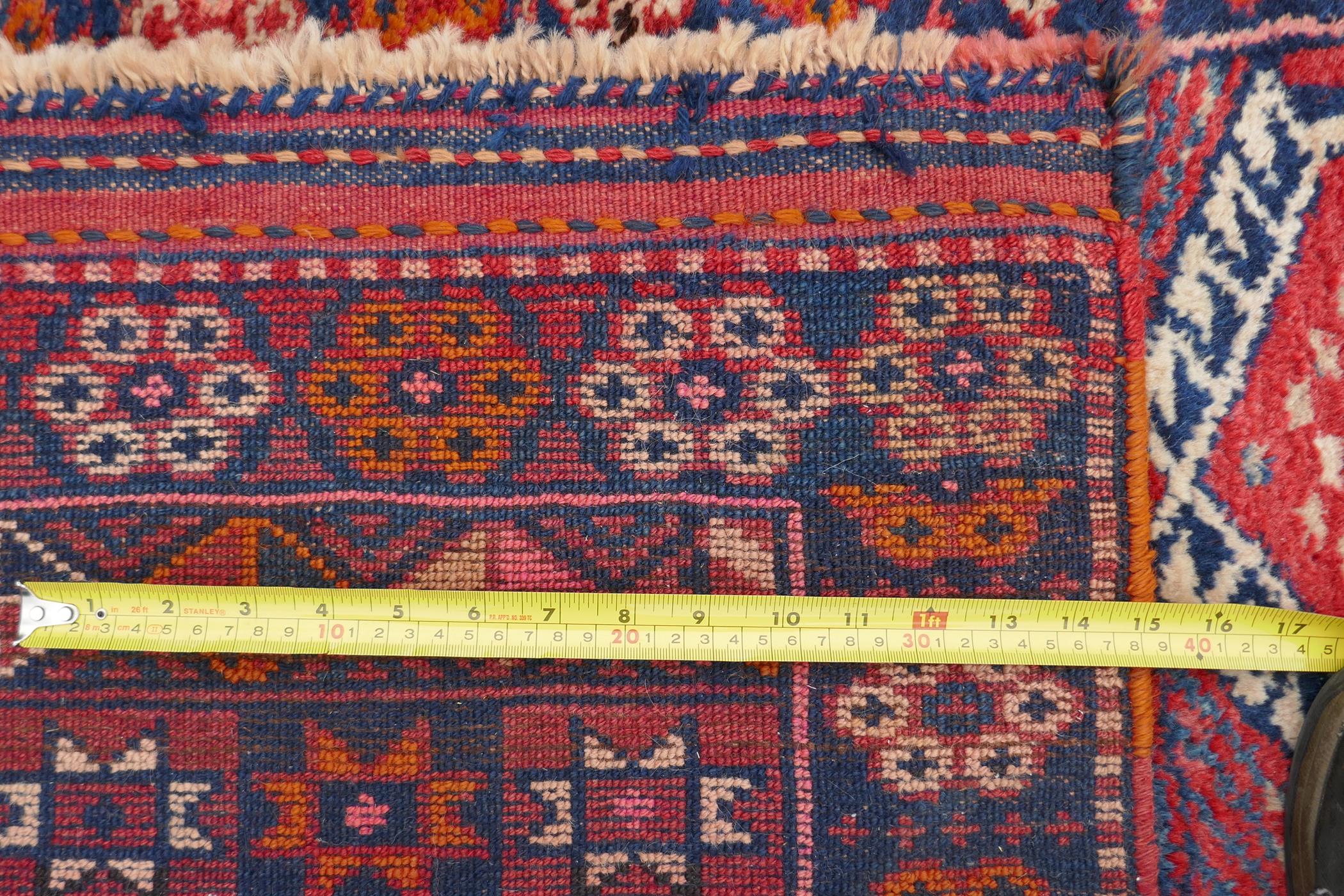A Kurdish red ground full pile village rug/runner with unique geometric design, 290cm x 98cm - Image 7 of 7