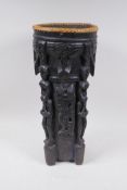 An Indonesian Dayak tribal carved and ebonised wood stick stand with figural and animal