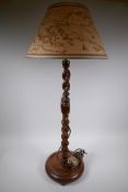 An oak barley twist column table lamp with world map shade, 87cm high