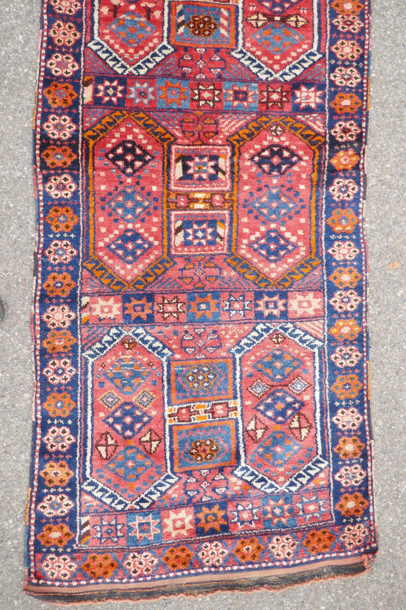 A Kurdish red ground full pile village rug/runner with unique geometric design, 290cm x 98cm - Image 3 of 7