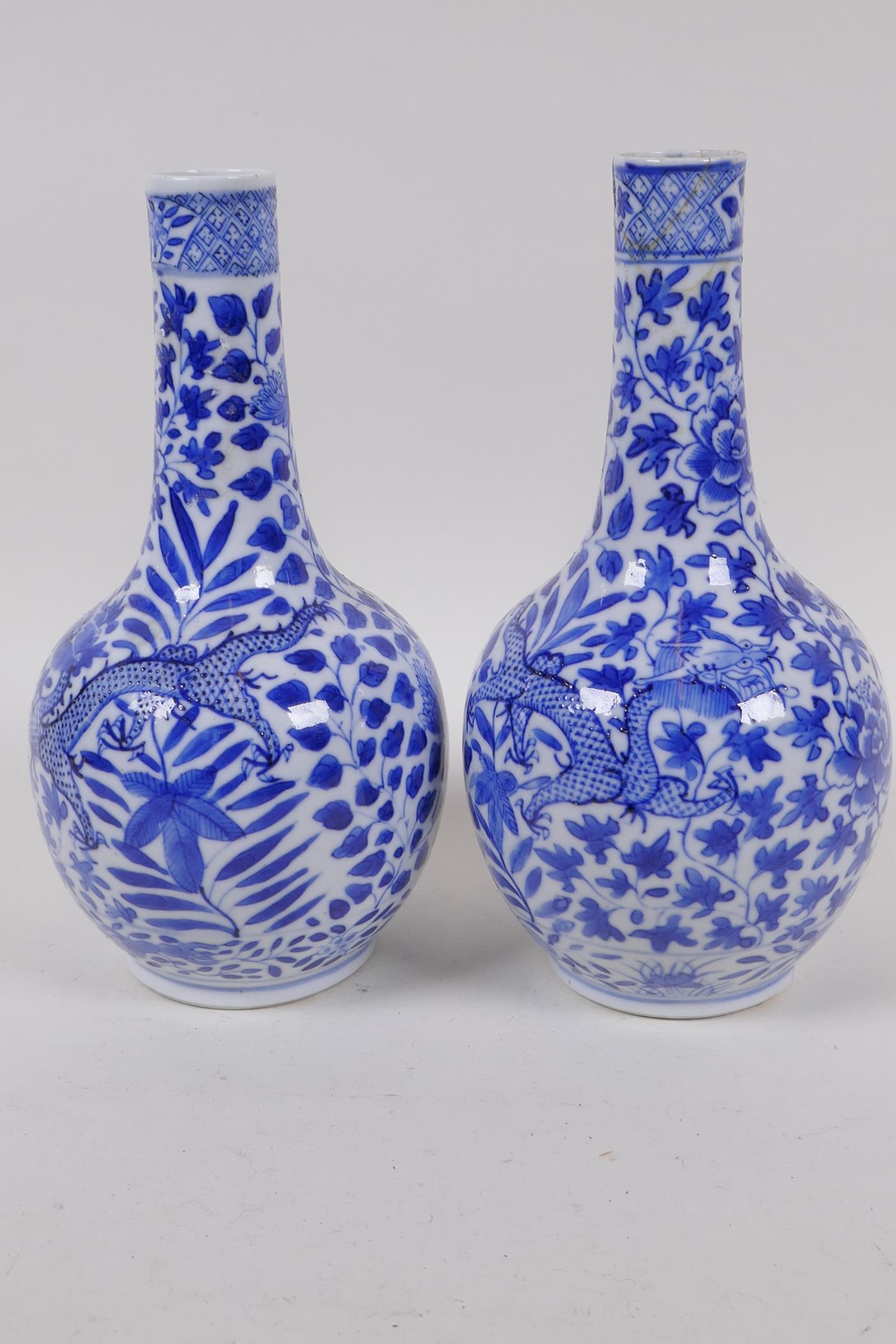 A pair of Chinese blue and white bottle vases decorated with dragons amongst foliage, KangXi 4