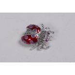 A 925 silver and enamel ladybird brooch set with marcasite and red stones, 3cm