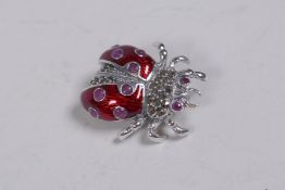 A 925 silver and enamel ladybird brooch set with marcasite and red stones, 3cm
