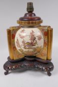 A Japanese Satsuma porcelain lamp base painted with birds amongst flowering trees, on a profusely