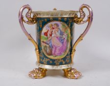 A Vienna style porcelain tyg with gilt highlights, raised on paw feet, 20cm high