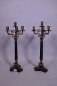 A pair of Empire style painted metal and brass mounted three branch candelabra, with fluted