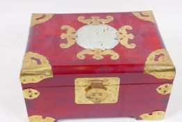 A Chinese brass bound jewellery chest, the cover set with a jade plaque, with a fitted interior,