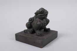 A Chinese bronze seal with a kylin knop, 9 x 9cm